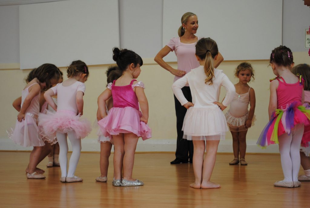 Ballet teacher guiding 18-month-old toddlers in creative movement at Randwick dance studio for young children